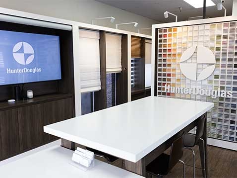 Store interior showcasing several different types of window coverings